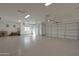Spacious three car garage with epoxy floors, three garage doors, and natural light at 16832 E Hazeltine Way, Queen Creek, AZ 85142