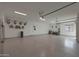This garage is a spacious area with a clean epoxy floor, bright lighting, and a functional design at 16832 E Hazeltine Way, Queen Creek, AZ 85142