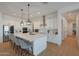 A modern kitchen with a large island, pendant lighting, stainless steel appliances and ample counter space at 16832 E Hazeltine Way, Queen Creek, AZ 85142