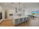 A modern kitchen with a large island, pendant lighting, stainless steel appliances and ample counter space at 16832 E Hazeltine Way, Queen Creek, AZ 85142