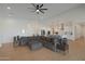 Spacious living room featuring an open floor plan with modern furnishings and access to the kitchen at 16832 E Hazeltine Way, Queen Creek, AZ 85142
