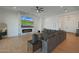 Spacious living room with a brick fireplace, a large sectional sofa, and neutral decor at 16832 E Hazeltine Way, Queen Creek, AZ 85142