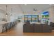Open-concept living space features a modern fireplace, white brick accent wall, and seamless flow to outdoor views at 16832 E Hazeltine Way, Queen Creek, AZ 85142