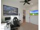 This bright office features a big screen, modern desk, and a ceiling fan at 16832 E Hazeltine Way, Queen Creek, AZ 85142