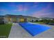 The in-ground pool offers a private retreat for relaxation and recreation, surrounded by well-manicured turf at 16832 E Hazeltine Way, Queen Creek, AZ 85142