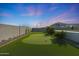 Backyard putting green provides a fun recreational feature for golf enthusiasts and adds to the outdoor charm at 16832 E Hazeltine Way, Queen Creek, AZ 85142