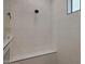 Close up of white tiled shower, black fixtures, a bench and a niche shelf for bath products at 16832 E Hazeltine Way, Queen Creek, AZ 85142