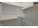 Bright walk-in closet features lots of shelf space and rods for hanging at 16832 E Hazeltine Way, Queen Creek, AZ 85142
