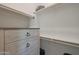 Spacious walk-in closet featuring wood-grain dresser drawers and lots of shelf space at 16832 E Hazeltine Way, Queen Creek, AZ 85142