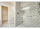 Bathroom with a glass shower featuring herringbone tile and a gray tiled floor at 17132 N Silver Path, Surprise, AZ 85374