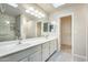 Bathroom vanity with double sinks, large mirror and modern lighting at 17132 N Silver Path, Surprise, AZ 85374
