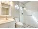 Stylish bathroom featuring a glass-enclosed shower with gray pebble floor and modern fixtures at 17132 N Silver Path, Surprise, AZ 85374
