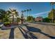 Entrance to community, features a tiered water fountain, palm trees, and manicured landscaping at 17132 N Silver Path, Surprise, AZ 85374