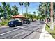 Gated community entrance featuring a guard house, lush landscaping, and vehicle access control for residents at 17132 N Silver Path, Surprise, AZ 85374