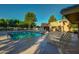 Community pool features lounge chairs and a shaded area for relaxing poolside at 17132 N Silver Path, Surprise, AZ 85374