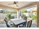 Serene covered patio with a ceiling fan and elegant table and chairs set, perfect for outdoor dining at 17132 N Silver Path, Surprise, AZ 85374