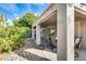 Spacious covered patio featuring a dining set, stone flooring, and access to the lush backyard garden at 17132 N Silver Path, Surprise, AZ 85374