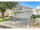 Attractive single-story home with a neutral facade, low-maintenance landscaping, and a brick driveway at 17132 N Silver Path, Surprise, AZ 85374