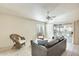 Cozy living room featuring tile flooring, neutral decor, and sliding glass doors to the backyard at 17132 N Silver Path, Surprise, AZ 85374