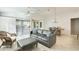 Bright and spacious living area with modern furnishings and seamless flow into dining space at 17132 N Silver Path, Surprise, AZ 85374