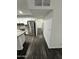 Hallway view of the kitchen with stainless steel appliances and dark wood floors at 1734 E Wier Ave, Phoenix, AZ 85040