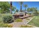 Elegant stone entry sign with lush landscaping, creating a welcoming and prestigious entrance to the community at 18431 W Cinnabar Ave, Waddell, AZ 85355