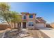 Charming two-story home featuring a manicured front yard with a brick pathway leading to the front door at 18431 W Cinnabar Ave, Waddell, AZ 85355