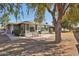 View of the back of the home from the backyard featuring a partially enclosed porch area at 18614 N Conestoga Dr, Sun City, AZ 85373