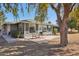 Backyard area showcasing a covered patio with a seating area, perfect for outdoor relaxation and entertainment at 18614 N Conestoga Dr, Sun City, AZ 85373