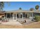 The sunroom is featured in this view of the rear exterior of home at 18614 N Conestoga Dr, Sun City, AZ 85373