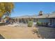 Large backyard featuring a covered patio area with green shrubs at 18614 N Conestoga Dr, Sun City, AZ 85373