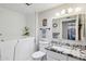Bright bathroom with a walk-in tub, granite countertop, and ample lighting above the mirror at 18614 N Conestoga Dr, Sun City, AZ 85373