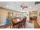 Elegant dining room featuring a large wooden table, stylish buffet, and adjoining living space at 18614 N Conestoga Dr, Sun City, AZ 85373