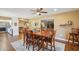 Bright dining room features a ceiling fan and a dining table for six with views into other living spaces at 18614 N Conestoga Dr, Sun City, AZ 85373
