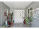 A welcoming covered entryway featuring a decorative door with sidelights and stylish decor at 18614 N Conestoga Dr, Sun City, AZ 85373