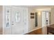 The grand foyer boasts hardwood floors and a decorative front door with sidelights at 18614 N Conestoga Dr, Sun City, AZ 85373