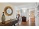 Entryway featuring hardwood floors, decorative mirror, with living area partially visible ahead at 18614 N Conestoga Dr, Sun City, AZ 85373
