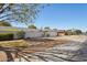 Street view of a single story home with well maintained yard, block wall, and mature landscaping at 18614 N Conestoga Dr, Sun City, AZ 85373