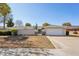 Charming single-story home featuring a well-maintained front yard and a two-car garage at 18614 N Conestoga Dr, Sun City, AZ 85373