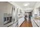 Spacious kitchen featuring stainless appliances, white cabinets, granite countertops, and wood flooring at 18614 N Conestoga Dr, Sun City, AZ 85373