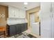 Functional laundry room with storage cabinets, a folding counter, and modern appliances at 18614 N Conestoga Dr, Sun City, AZ 85373