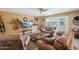 A comfortable living room with cozy seating, a ceiling fan, and decorative shelving at 18614 N Conestoga Dr, Sun City, AZ 85373