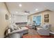 Inviting living room featuring built-in shelves, comfortable seating, and a ceiling fan at 18614 N Conestoga Dr, Sun City, AZ 85373