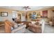 A comfortable living room features plush seating, neutral walls, and a ceiling fan at 18614 N Conestoga Dr, Sun City, AZ 85373