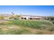 Well maintained golf course driving range at the clubhouse with mountain views in the distance at 18716 E White Wing Dr, Rio Verde, AZ 85263