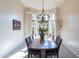 Bright dining room featuring a chandelier, seating for six and large windows with shutters at 18716 E White Wing Dr, Rio Verde, AZ 85263