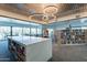 This bright library features floor-to-ceiling bookshelves and an abundance of comfortable seating areas at 18716 E White Wing Dr, Rio Verde, AZ 85263