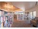 Well-stocked library with reading nooks and large windows offering views of the outside at 18716 E White Wing Dr, Rio Verde, AZ 85263