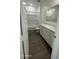 Bathroom featuring dark wood-look floors, bright white walls, and a white vanity at 18878 E Bruno Dr, Gold Canyon, AZ 85118