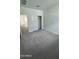 Cozy bedroom with neutral carpet, closet with bi-fold doors, and views to the neighboring landscape at 18878 E Bruno Dr, Gold Canyon, AZ 85118
